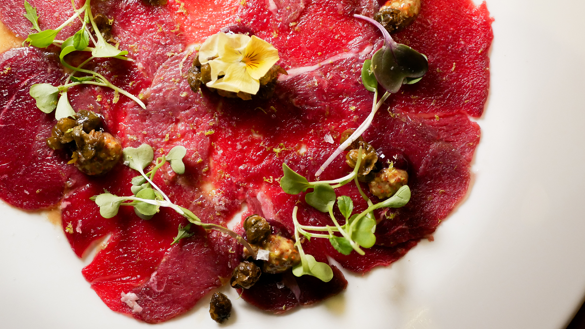 Carpaccio de solomillo de ciervo, con frutos rojos, mostaza y alcaparras crujientes
