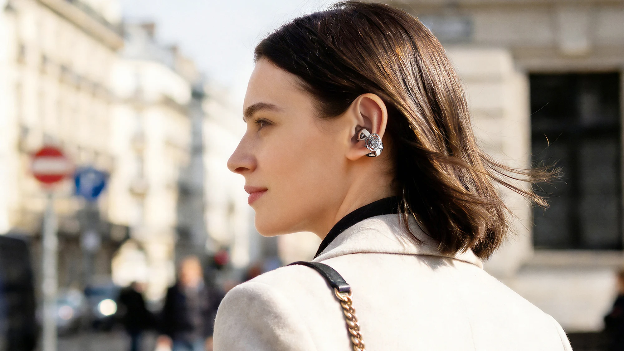 Vista de los auriculares Crystal Clip Swarovski llevados por una modelo en medio de la ciudad