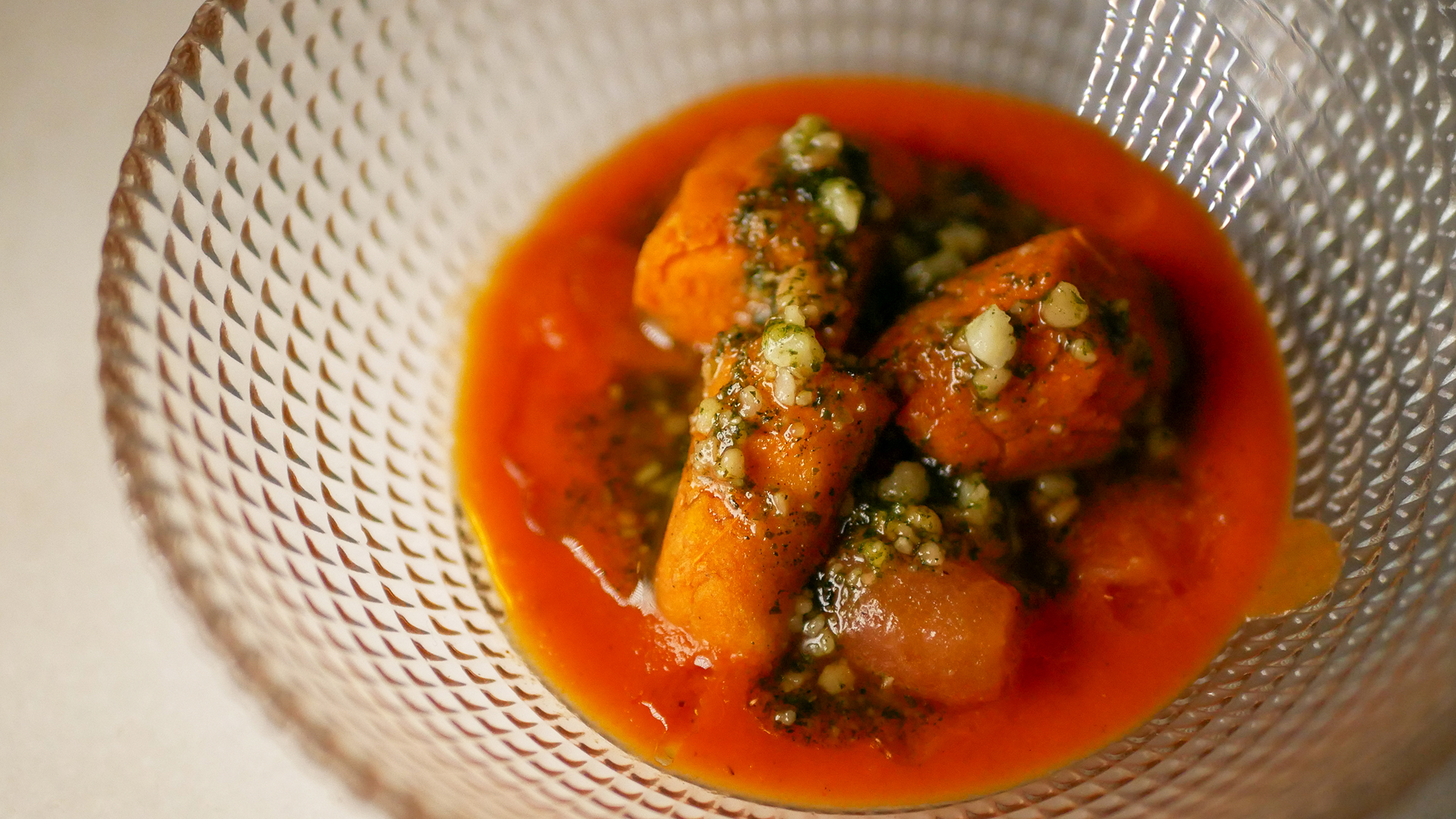 ñoquis de tomate con base de salsa de tomate, tomate concassé salteado y picada de pesto de anacardos